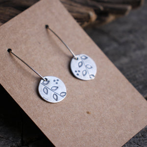 Branch with leaves stamped on silver disc Dangle earrings