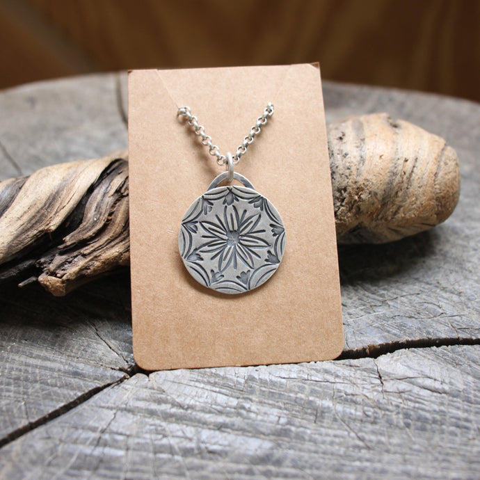 Flower stamped in middle of Mandala necklace