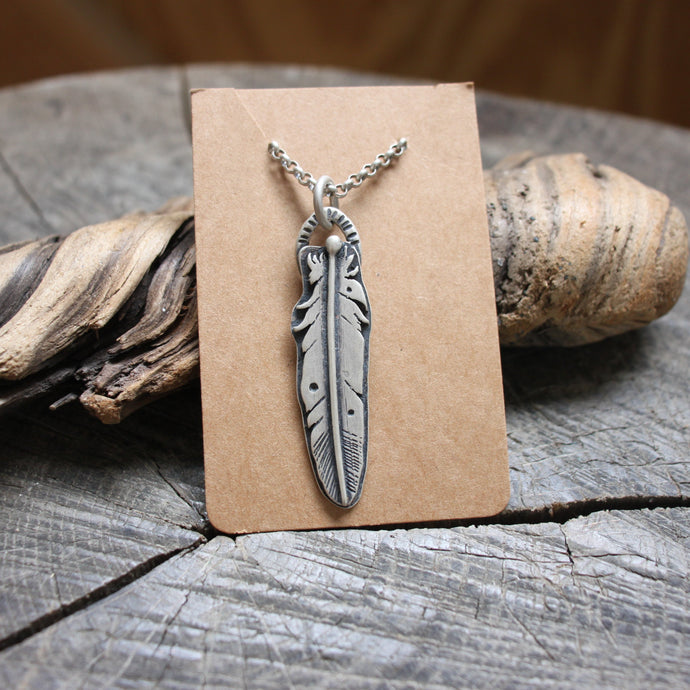 Silver feather necklace with dots and lines stamped on silver Rolo chain